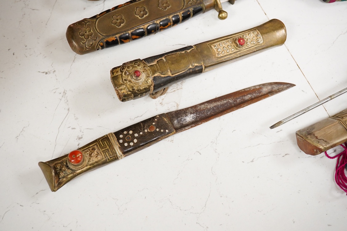 Four Tibetan daggers, early 20th century and a prayer wheel
